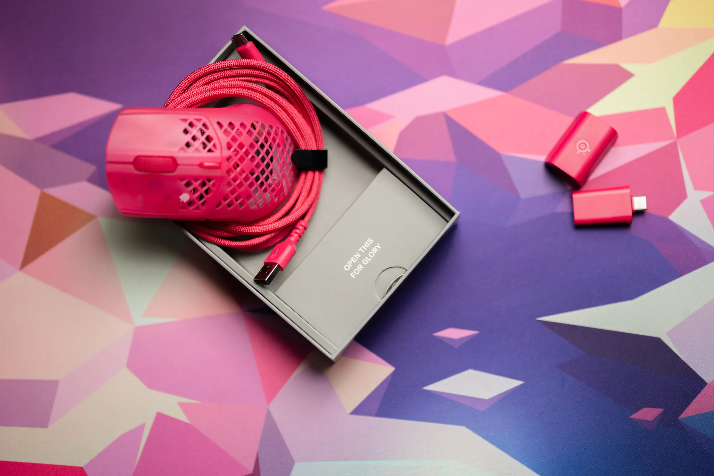 SteelSeries Aerox 3 Wireless Gen 2 in the box with pink cable and the text Open this for glory