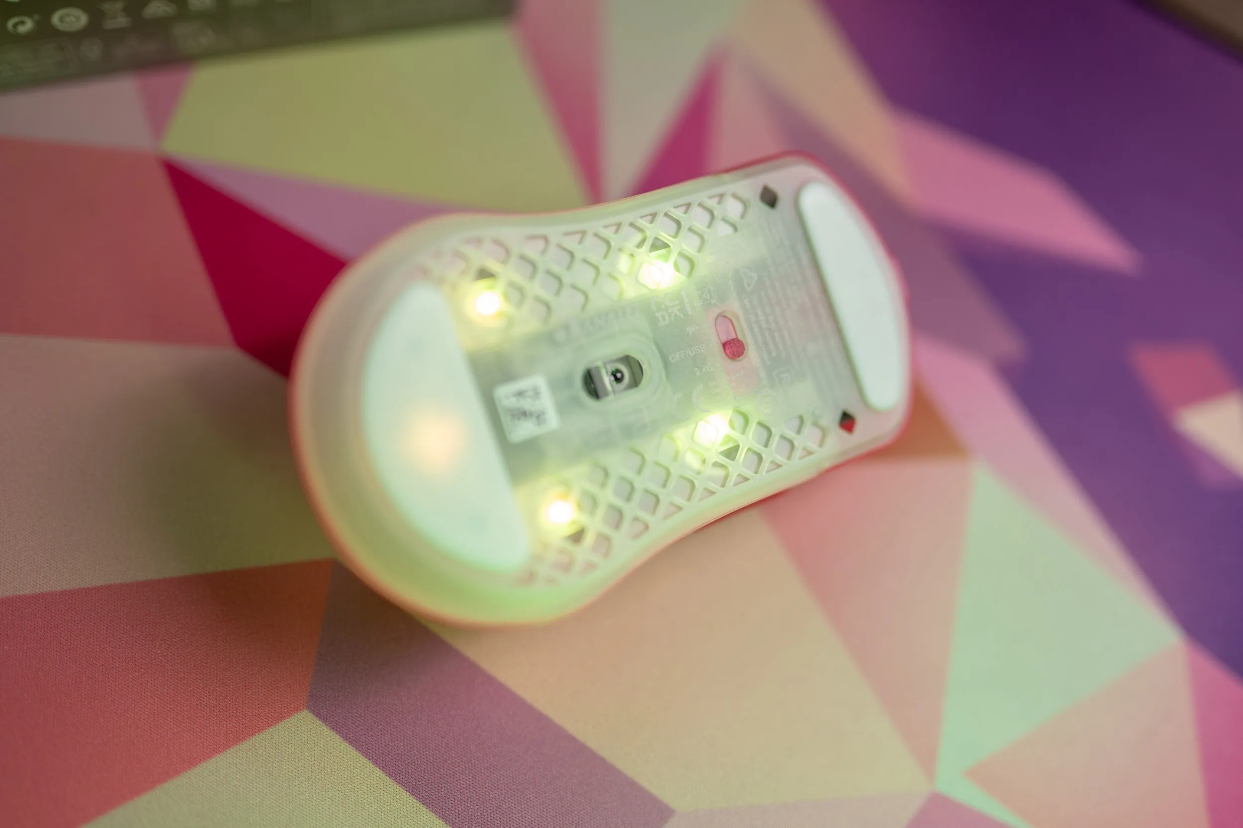 The underside of the Aerox 3 Wireless Gen 2 with LEDs, sensor and mode switch