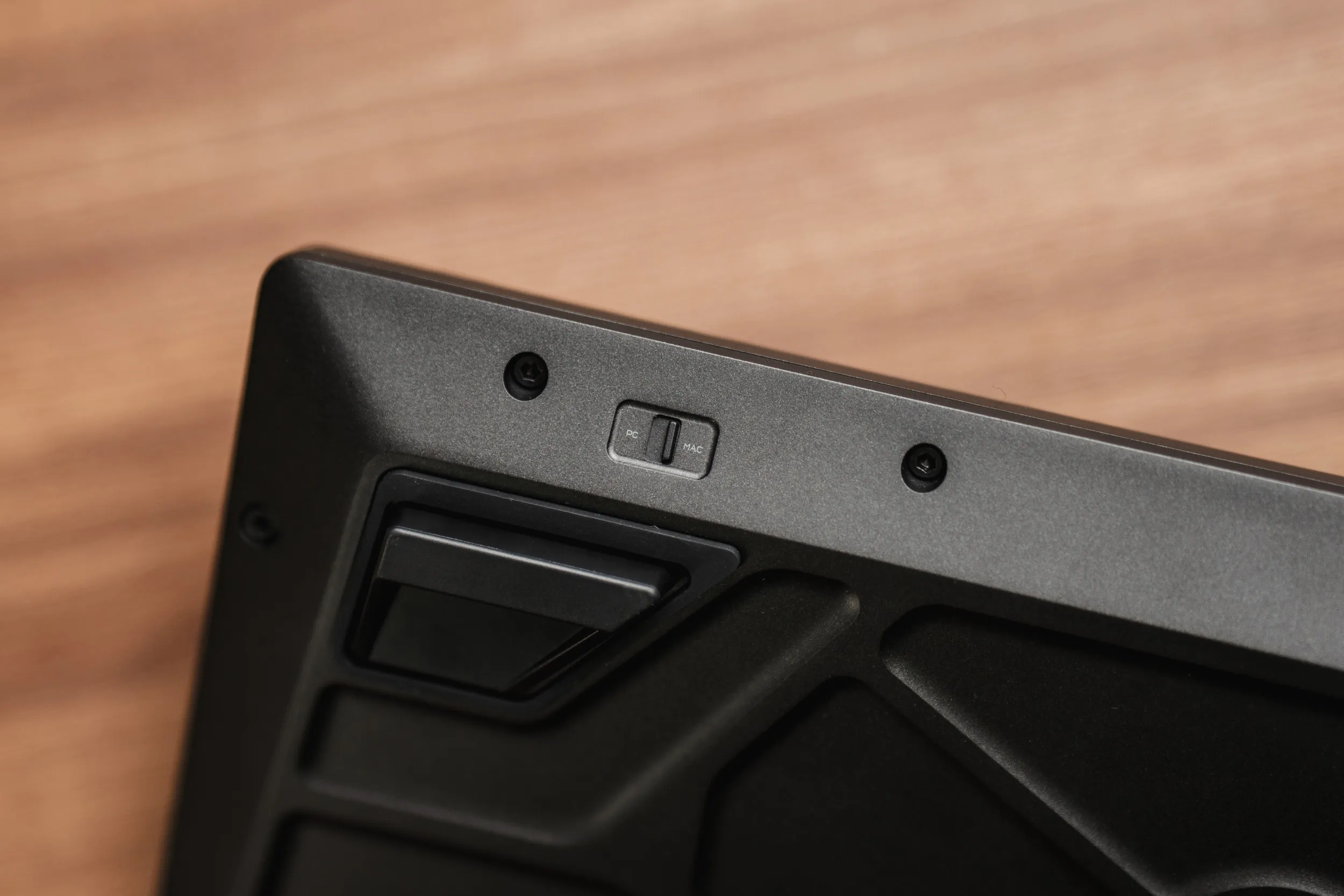 Close-up of the PC and Mac toggle switch recessed into the underside of the Corsair MAKR PRO 75