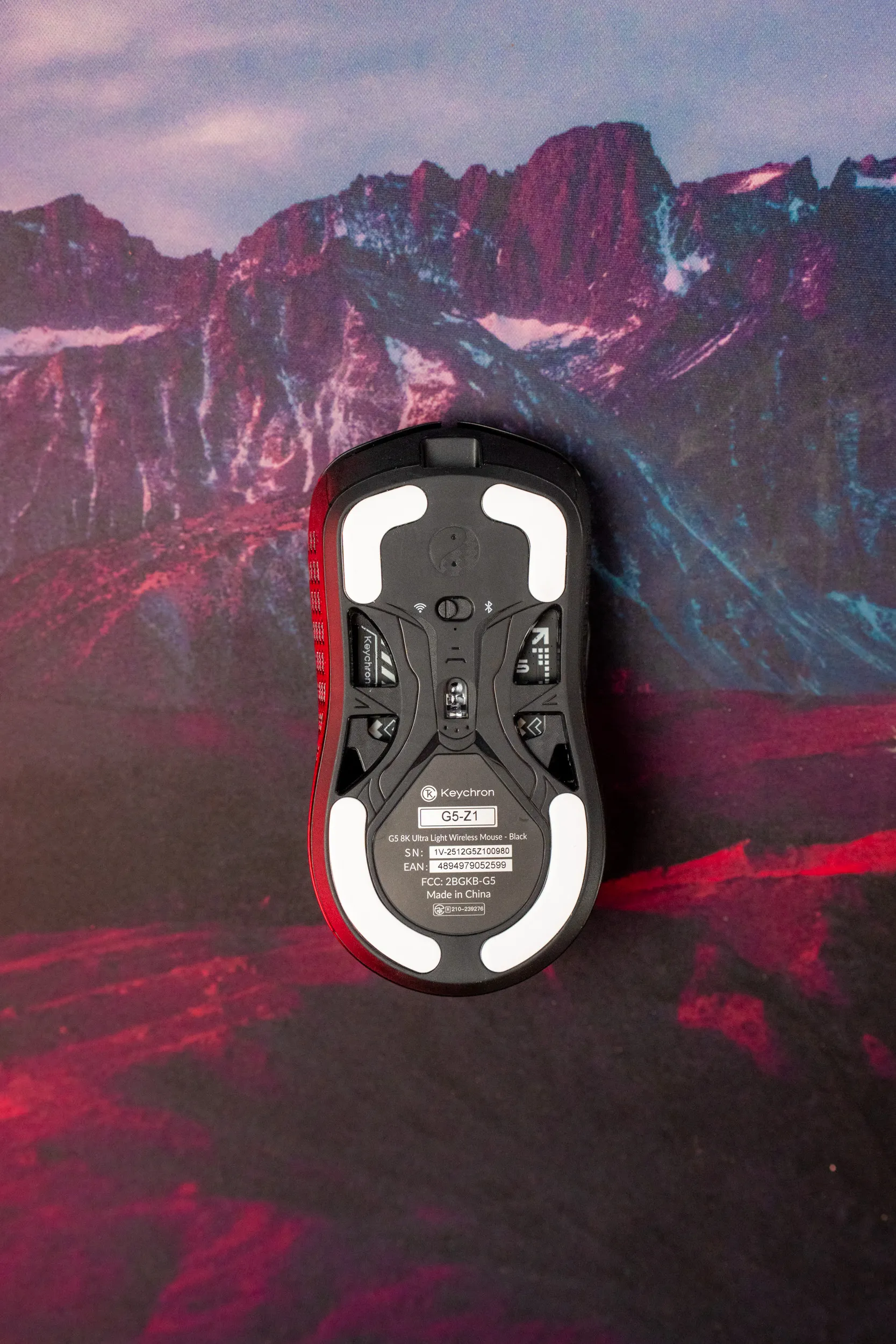 The underside of the Keychron G5 with factory-mounted skates and connectivity switches