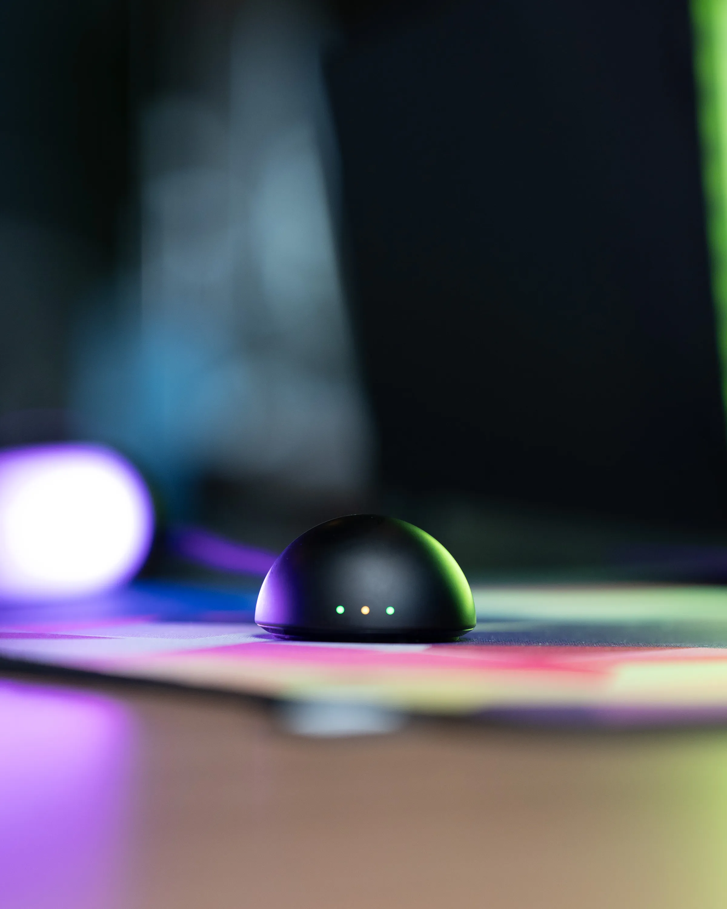The DeathAdder V4 Pro receiver puck on the desk