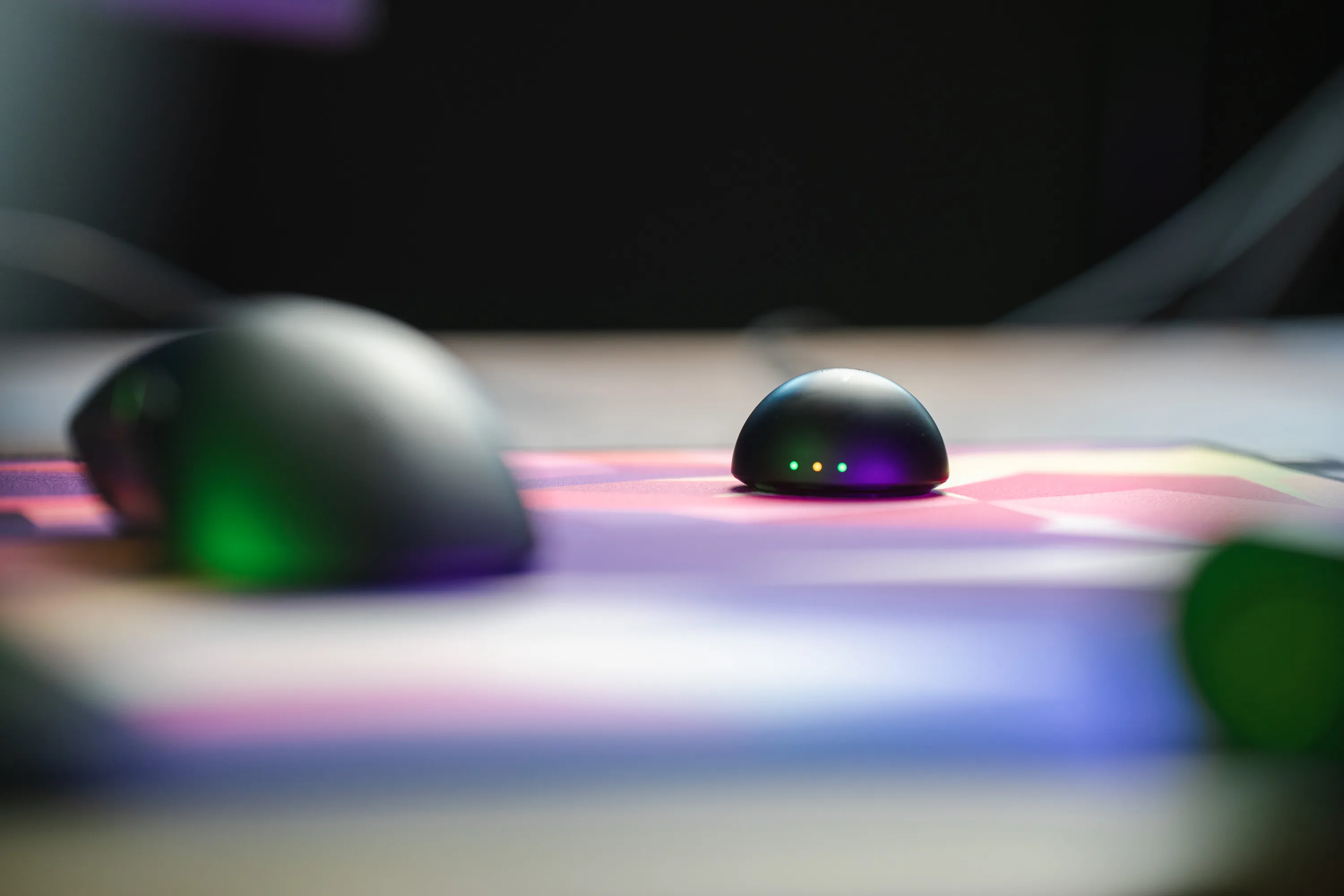 Razer DeathAdder V4 Pro next to its receiver puck