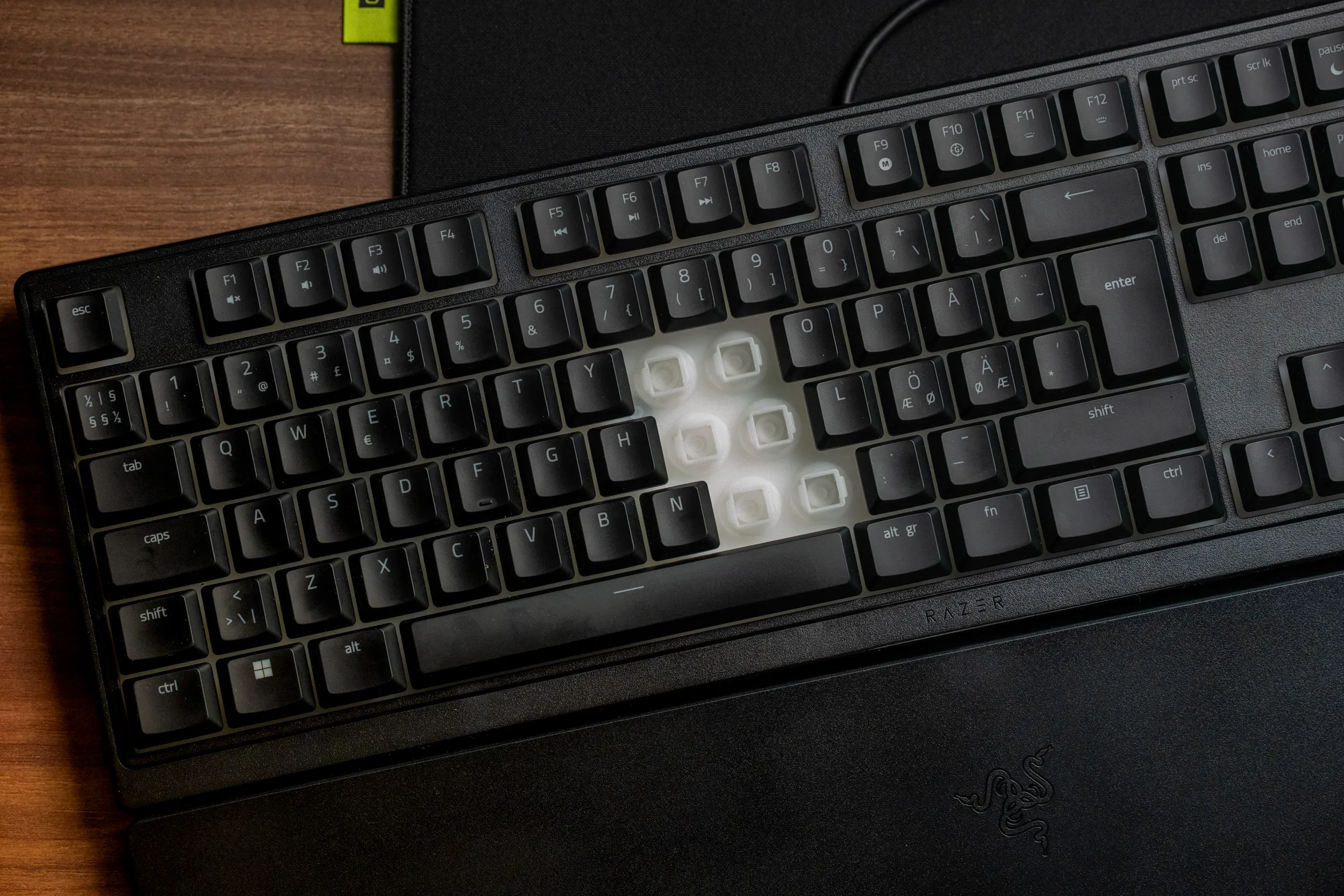 Razer Ornata V3 X with several keycaps removed, showing the white membrane domes underneath