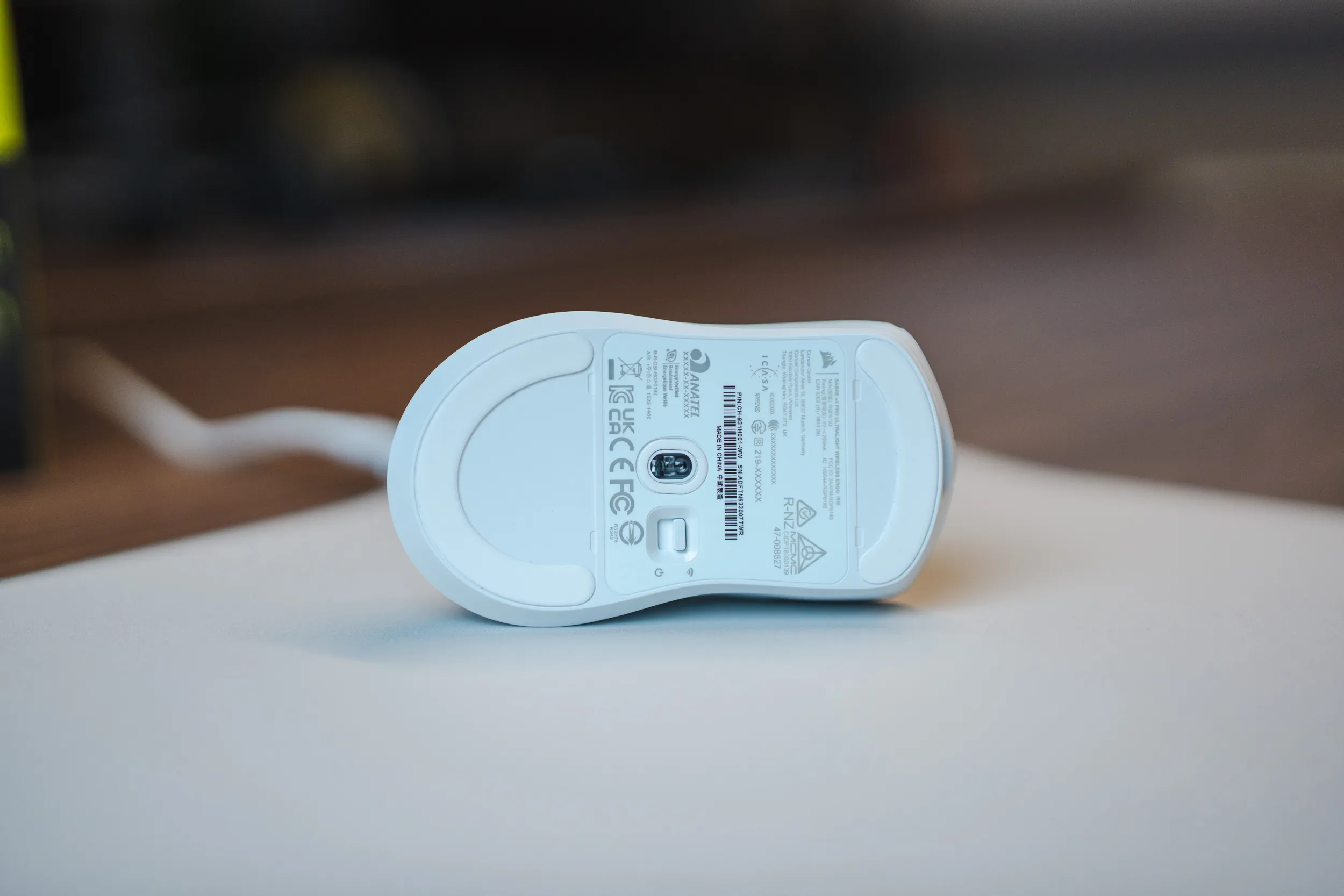 The underside of the Sabre v3 Pro PureVector in white, with the Marksman X sensor in the middle