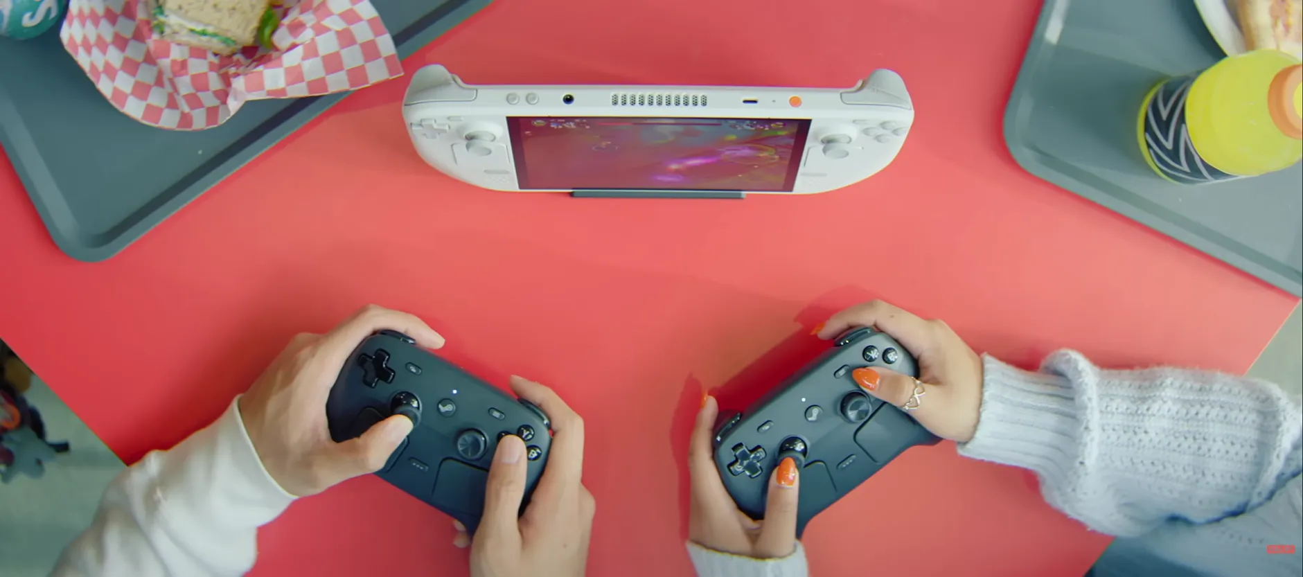 Two people playing couch co-op with a Steam Controller each