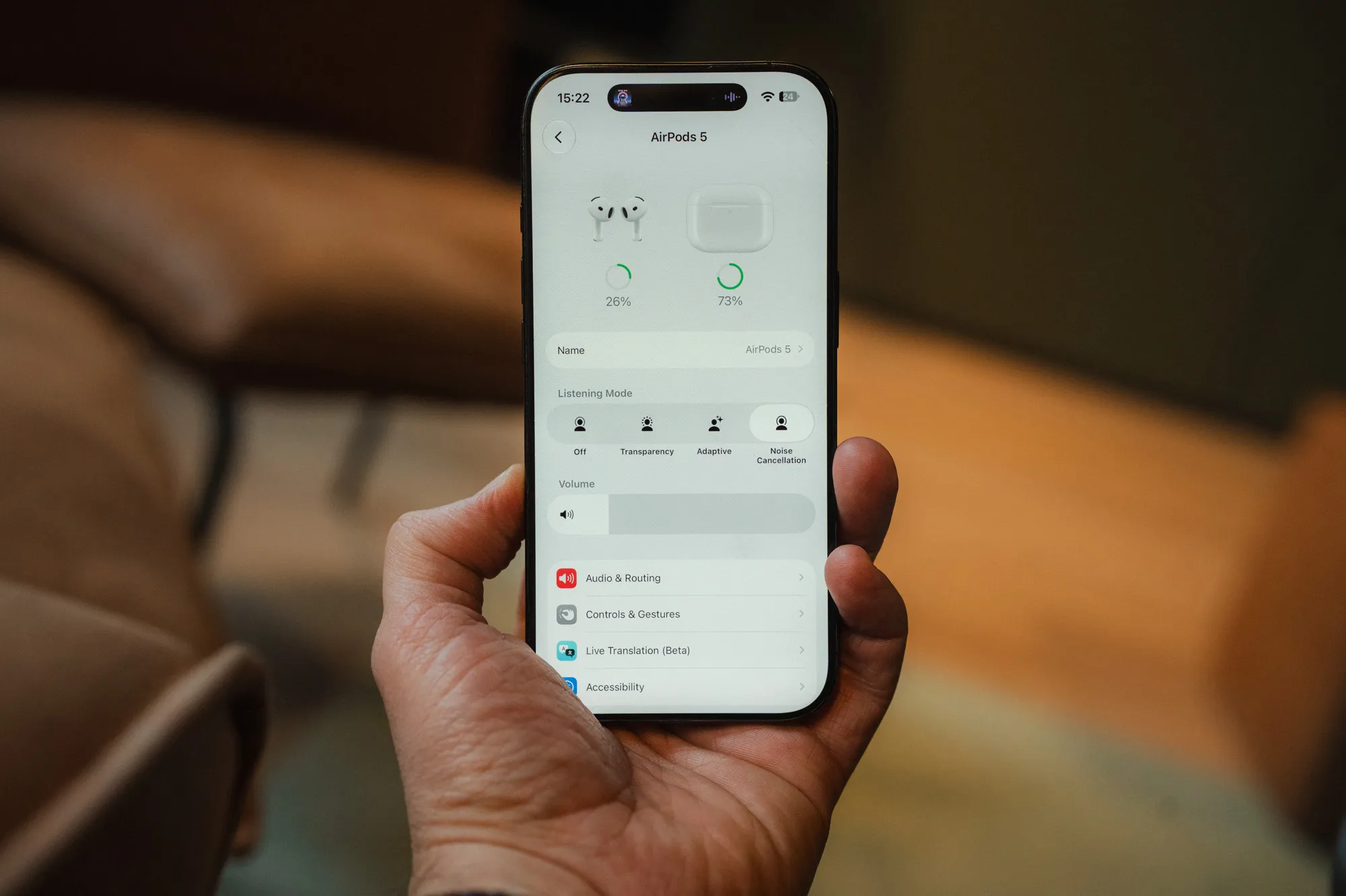 iPhone in hand showing the AirPods 5 settings, with the listening mode set to noise cancellation