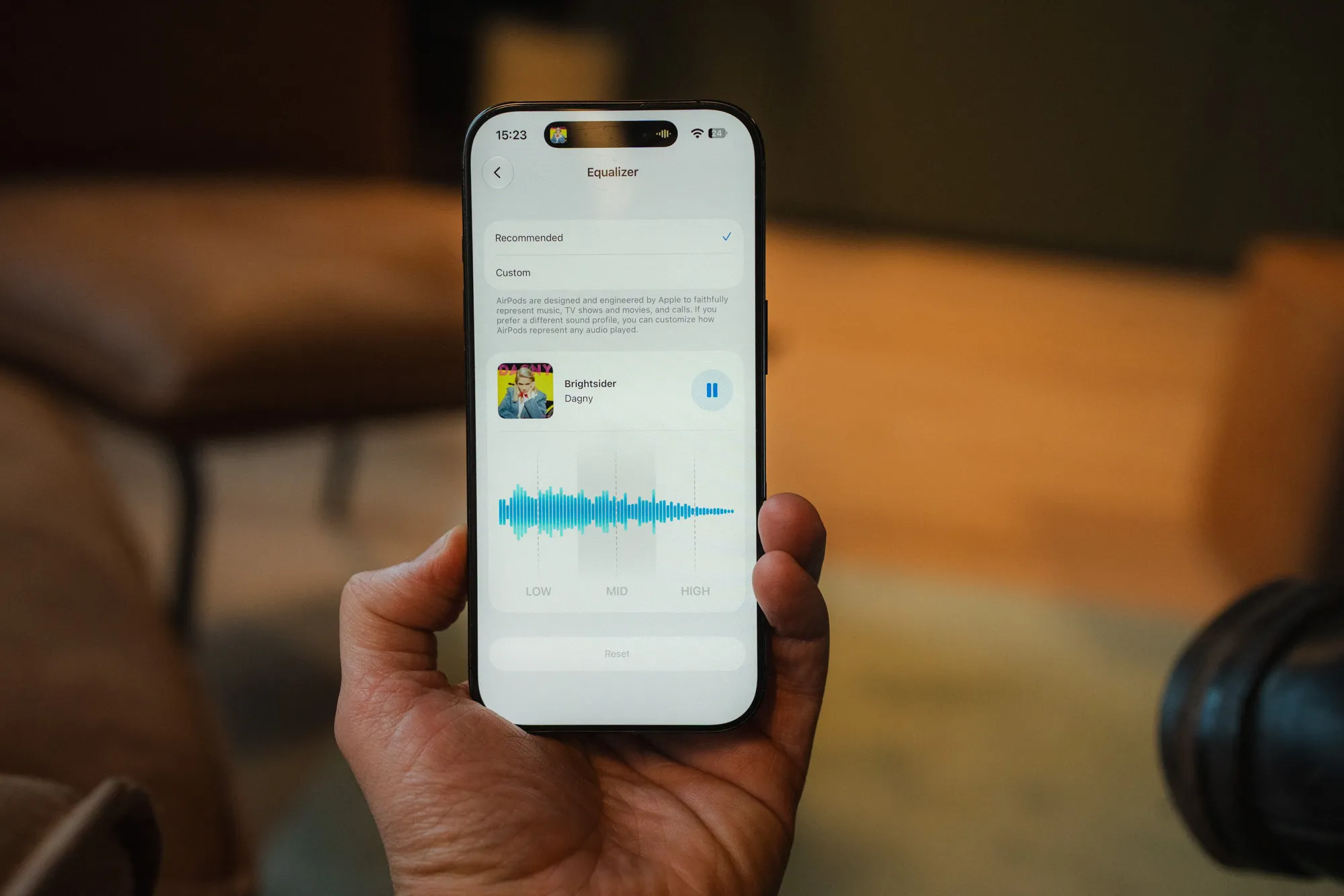 iPhone in hand showing the new equalizer in iOS 27 with three bands, low, mid and high
