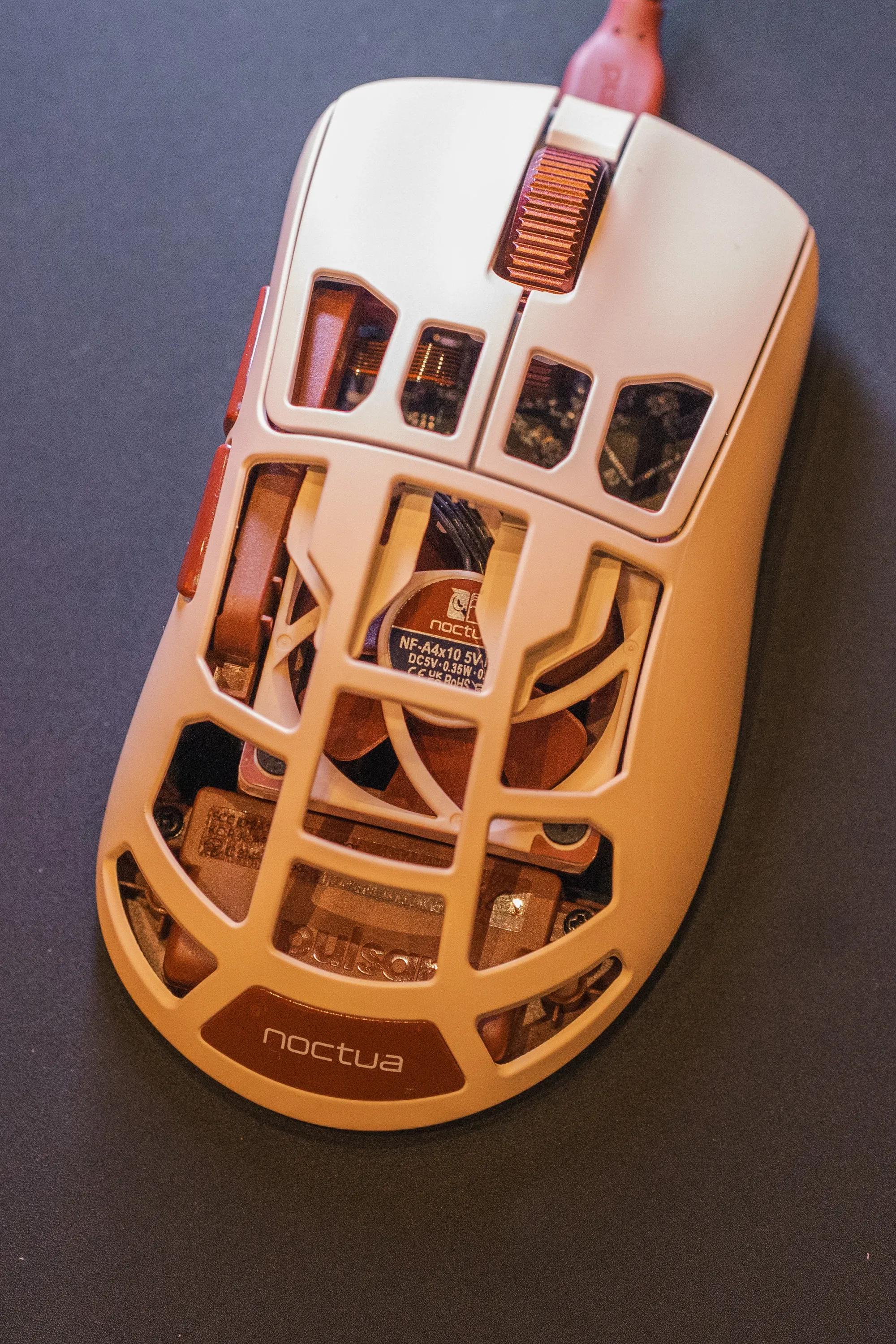 Close-up of the Pulsar Feinmann F01 Noctua Edition from above, with the Noctua NF-A4x10 fan visible through the open shell