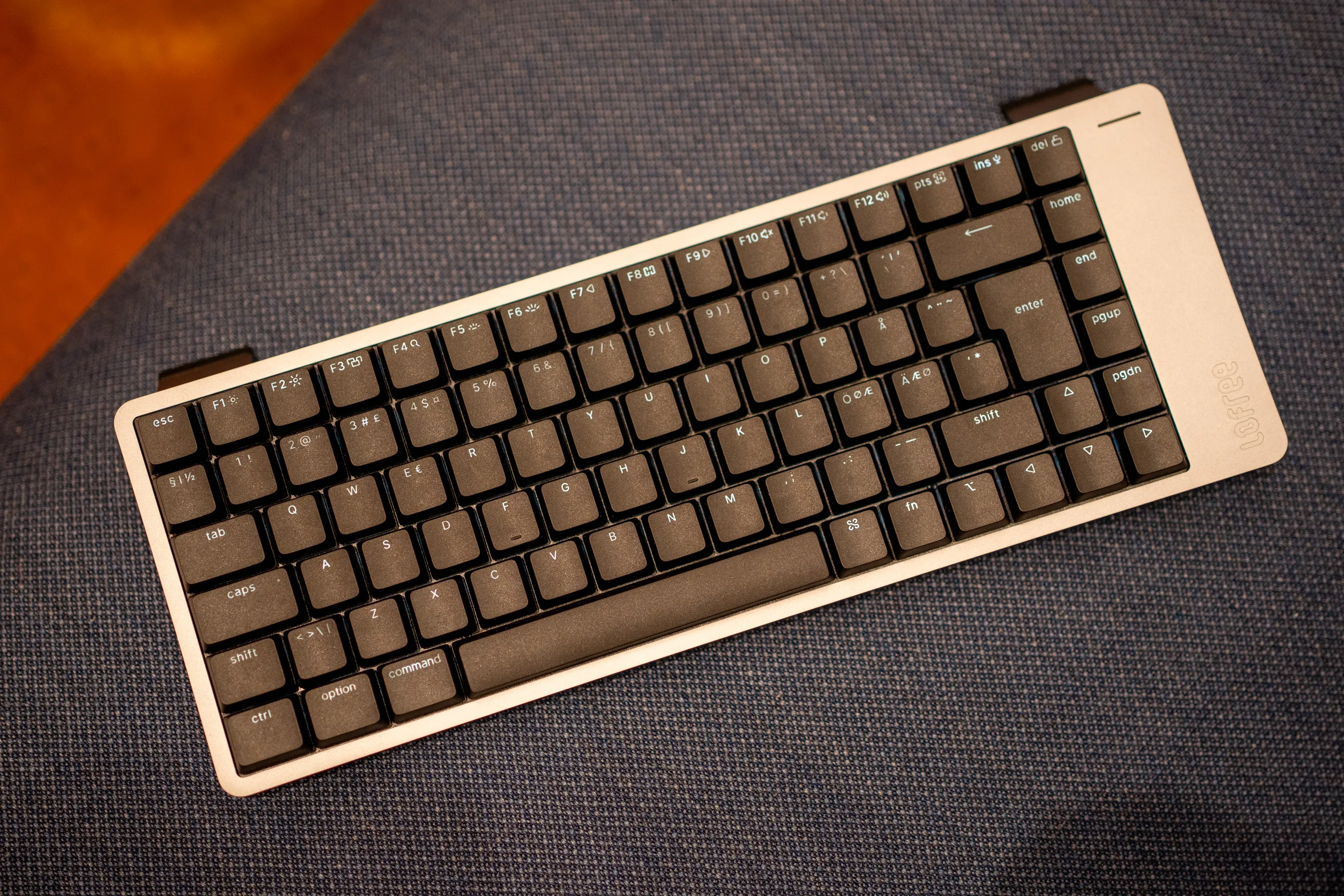 Lofree Flow 2 in black and grey seen from above at an angle, with Nordic ISO layout and the two kickstand feet flipped out at the back