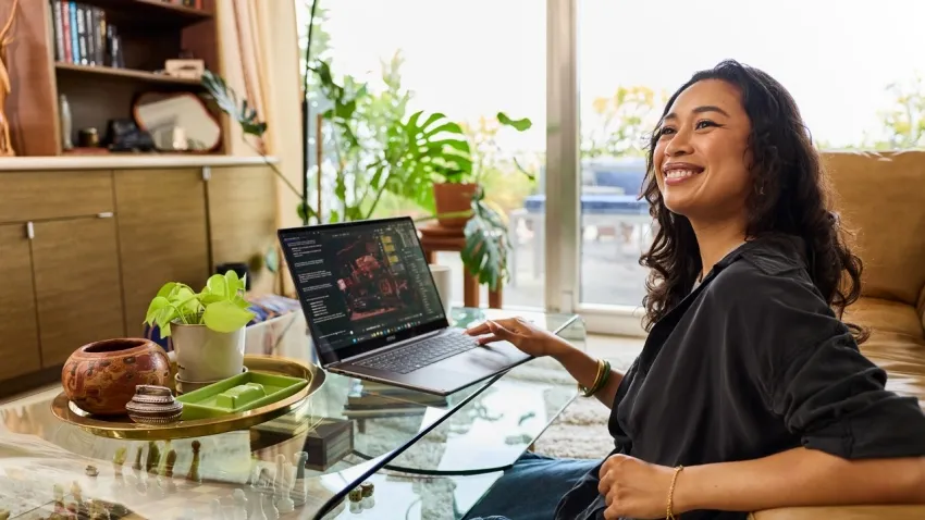 Woman on a sofa with an RTX Spark laptop on the coffee table