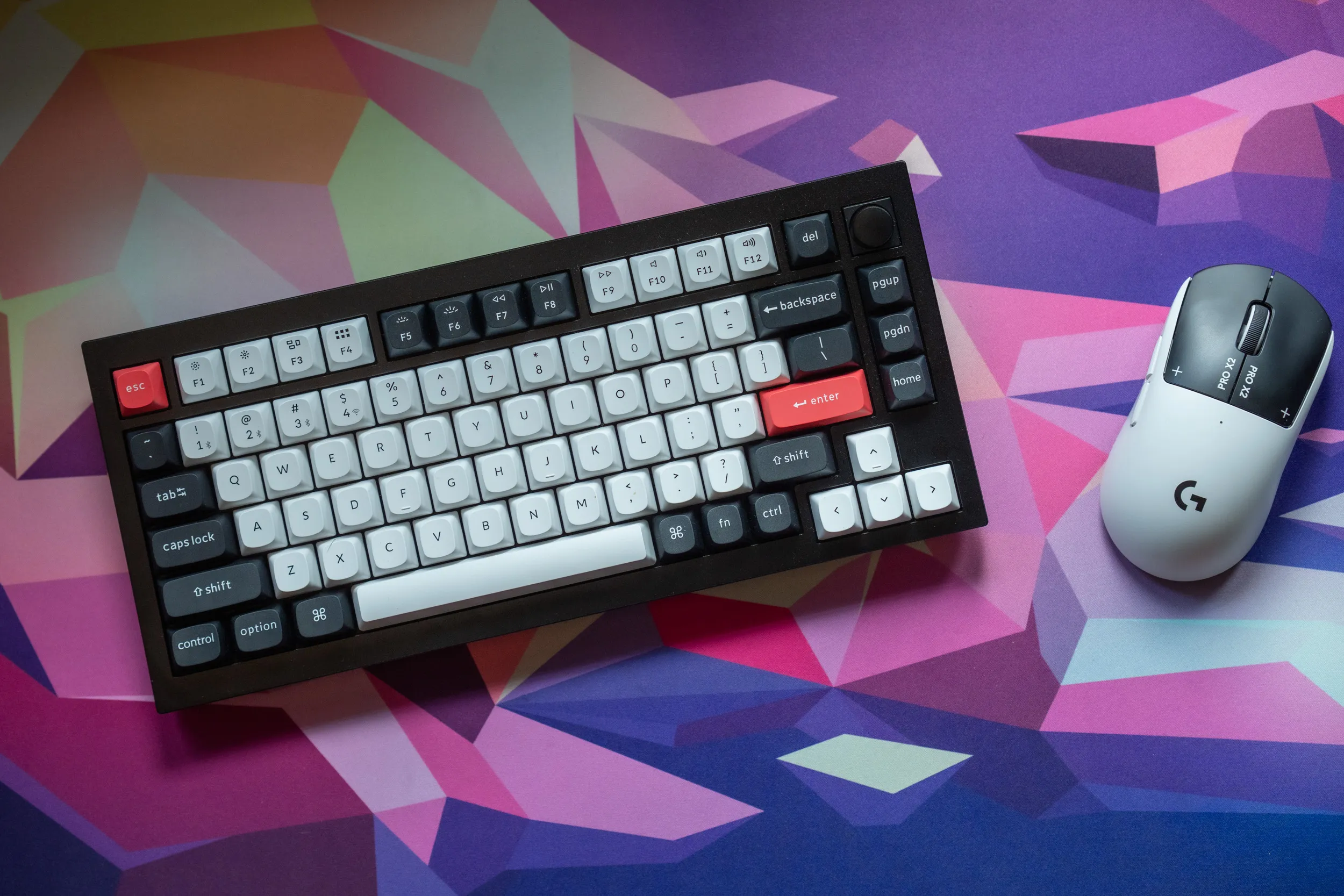 Keychron Q1 HE in 75% layout on a colourful mousepad, with knob and red enter key