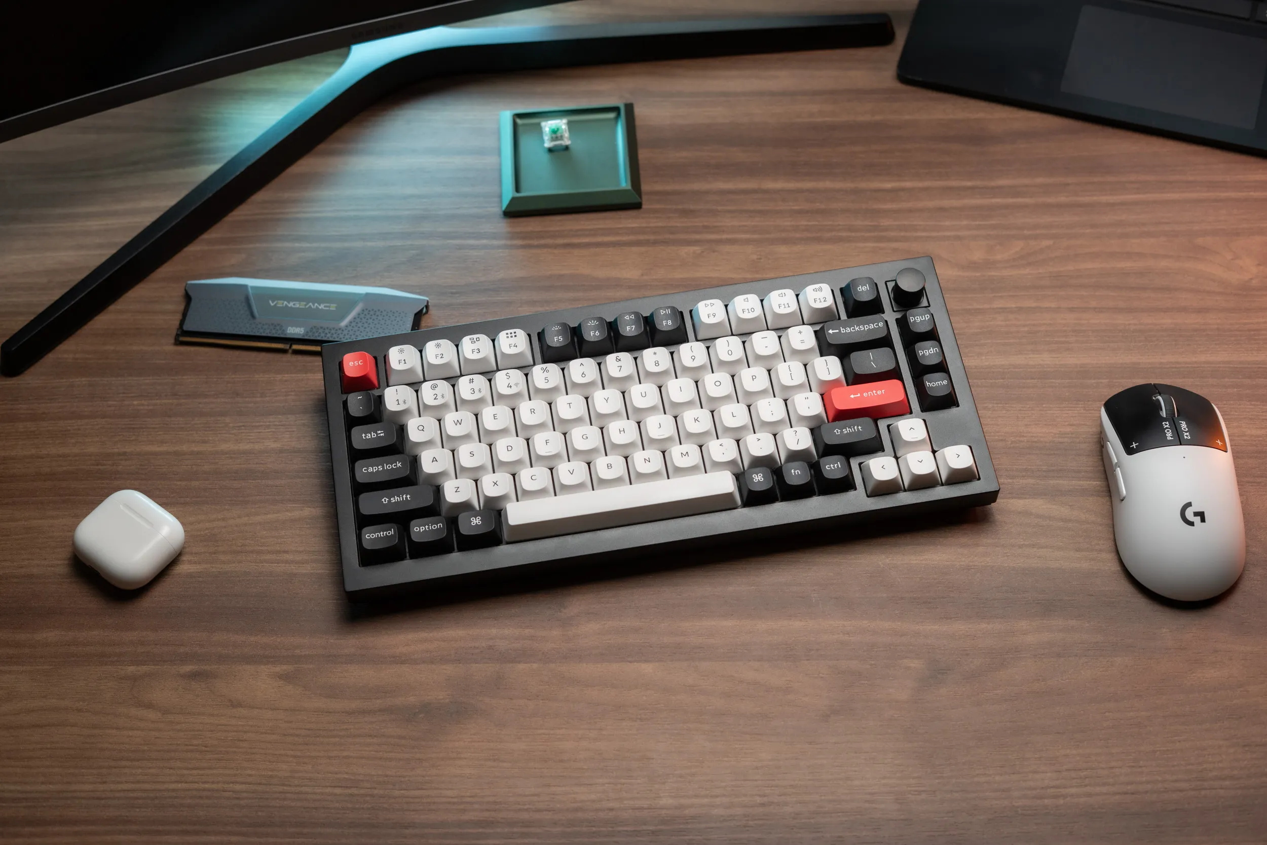 Keychron Q1 HE in ANSI on the desk, surrounded by a mouse, a RAM stick and a loose switch