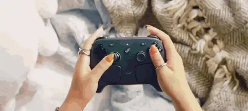 The new Steam Controller in motion, showing the trackpads, sticks and rear buttons