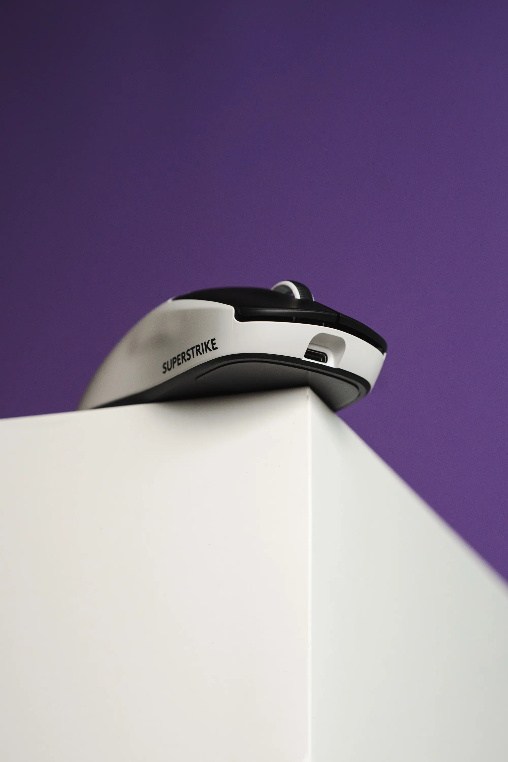Logitech G Pro X2 Superstrike seen from the side against a purple background