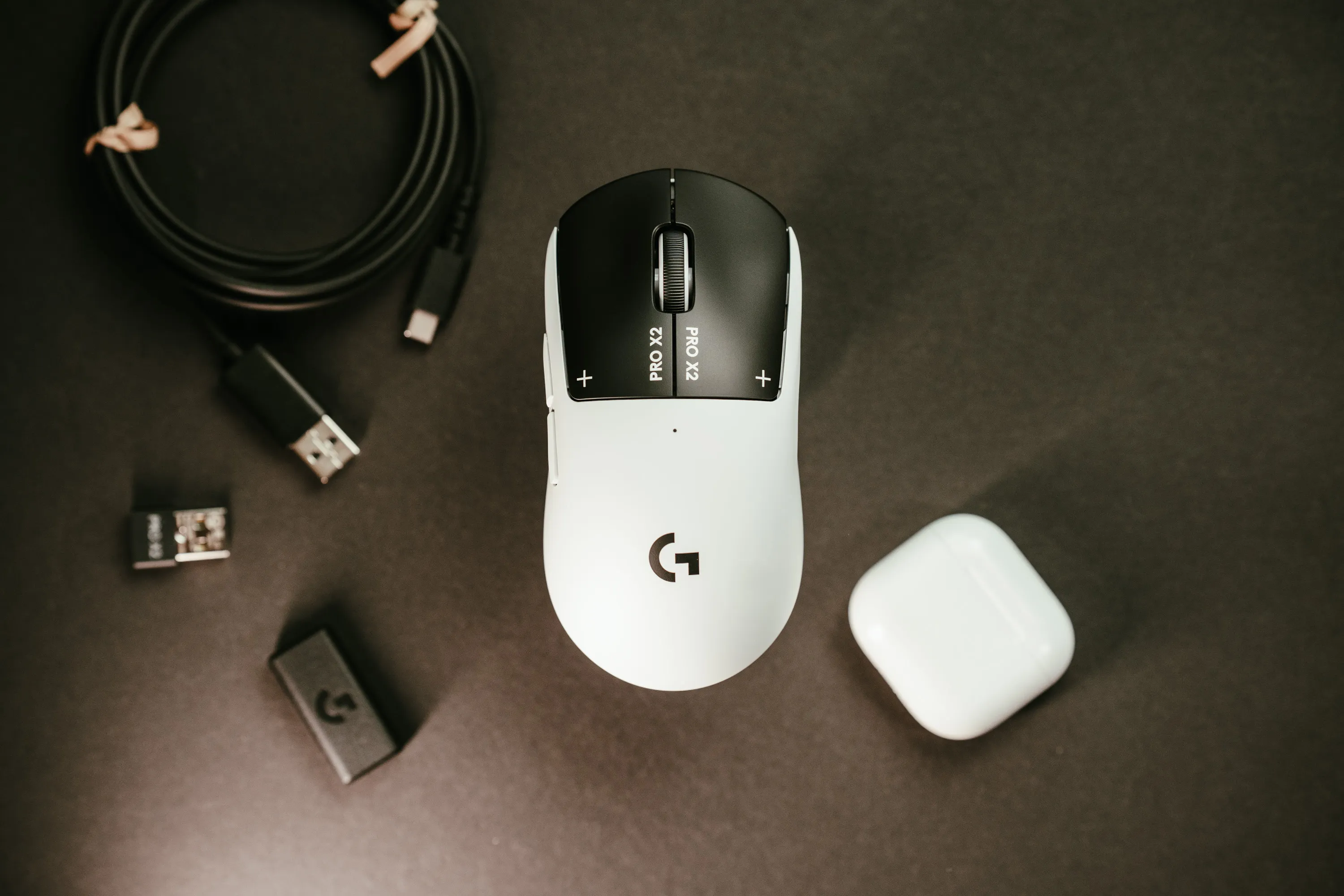 Logitech G Pro X2 Superstrike from above, with the USB cable, receiver and adapter next to it