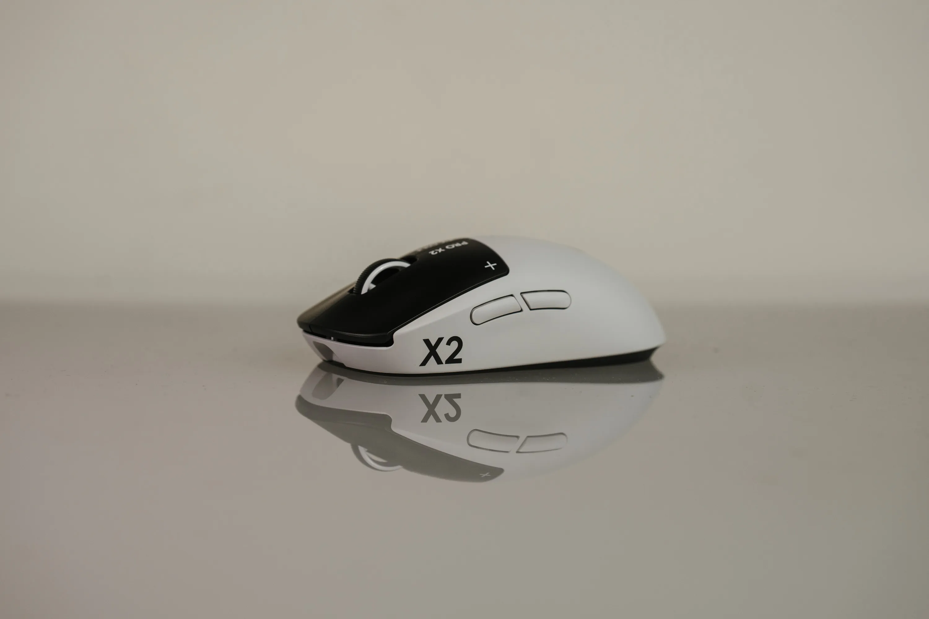 Logitech G Pro X2 Superstrike in white seen from the side, mirrored in the tabletop